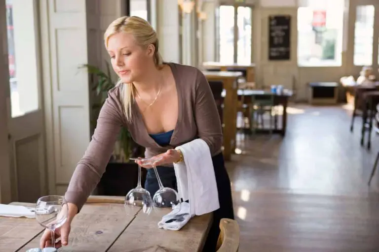 Waitress cleaning table