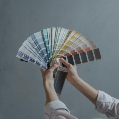 Person Holding Blue White and Red Hand Fan